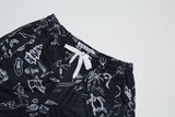 RECYCLED SWIM SHORTS IN BLACK TATTOO PRINT